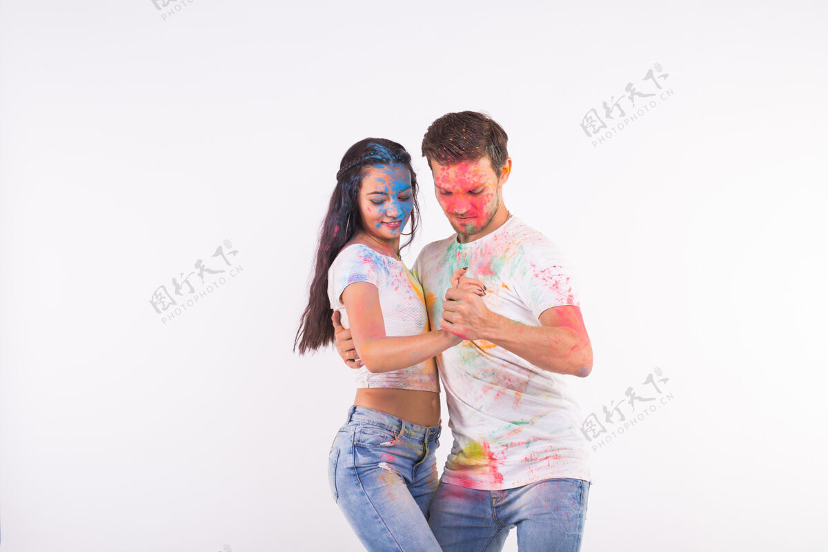 文化胡里节 社交舞蹈 友谊——年轻人在胡里节上玩色彩 在白色表面上用复制空间跳巴查塔或基佐巴舞飞溅肮脏传统