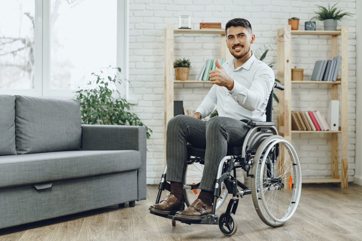 医疗坐在轮椅上快乐微笑的年轻人呆在家里强壮生命保健