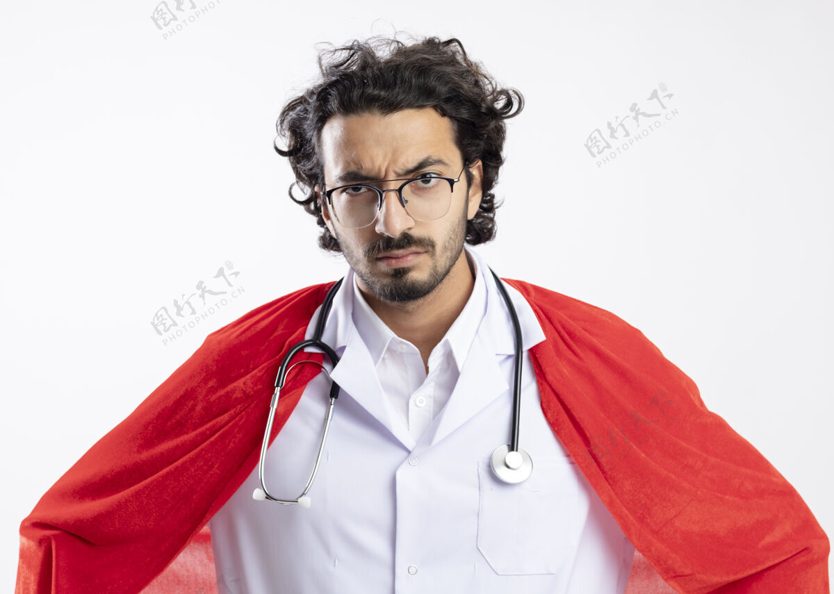 年轻严肃的年轻白种人超级英雄戴着眼镜 穿着医生制服 披着红色斗篷 脖子上戴着听诊器超级英雄严重男
