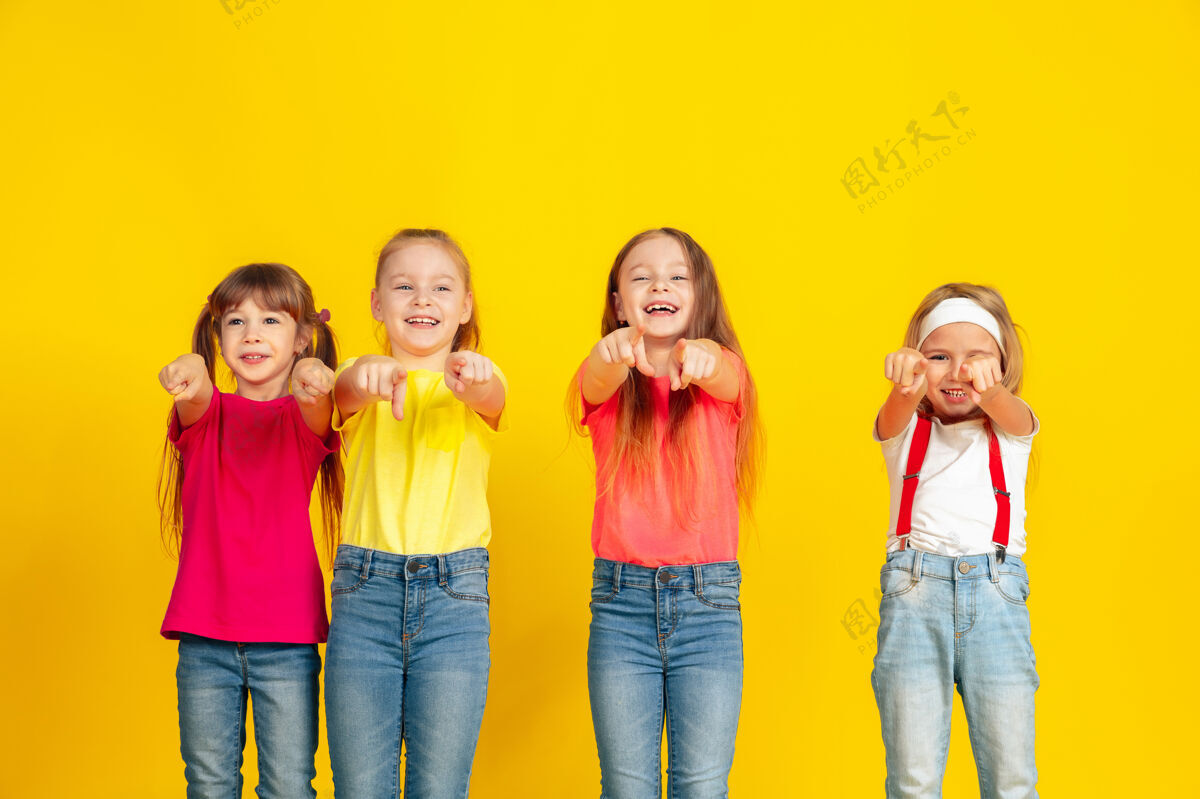 休闲快乐的孩子们一起在黄色的墙上玩耍和玩耍活动享受可爱