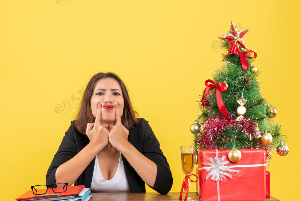 人新的一年心情与美丽的不满意紧张的业务女士困惑的东西 坐在一张桌子在办公室美丽黄色坐着