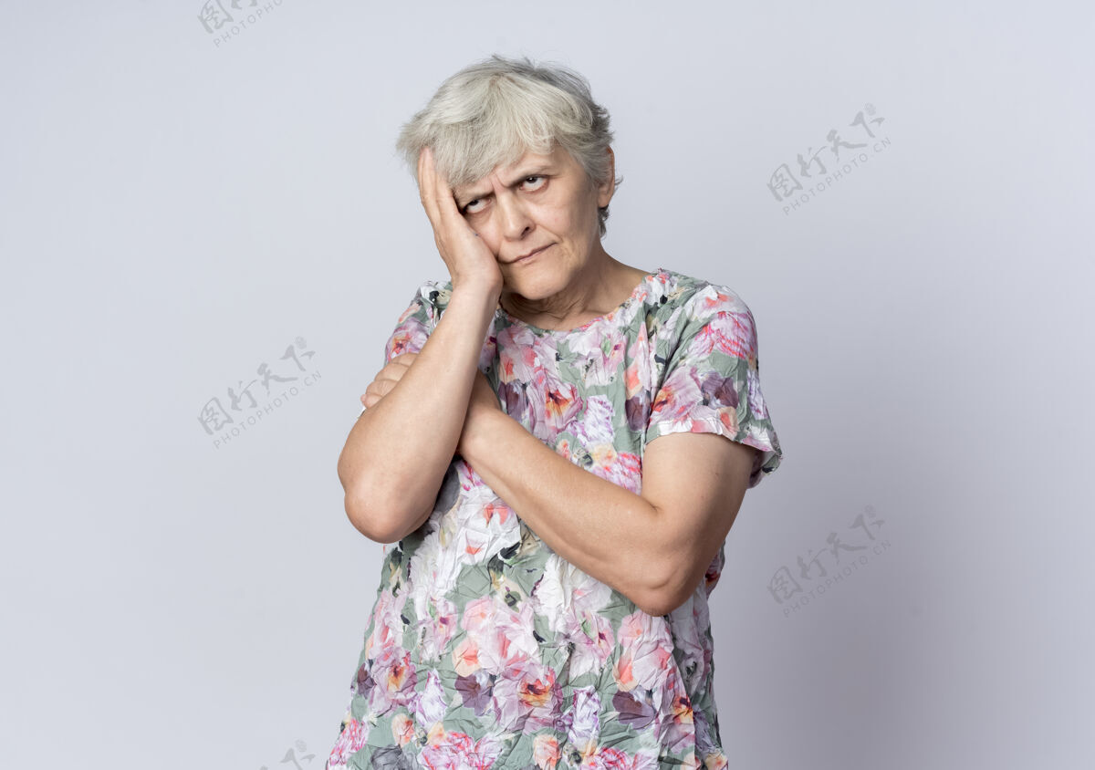 女人不高兴的老妇人把手放在隔离在白墙上的脸上手不高兴老人