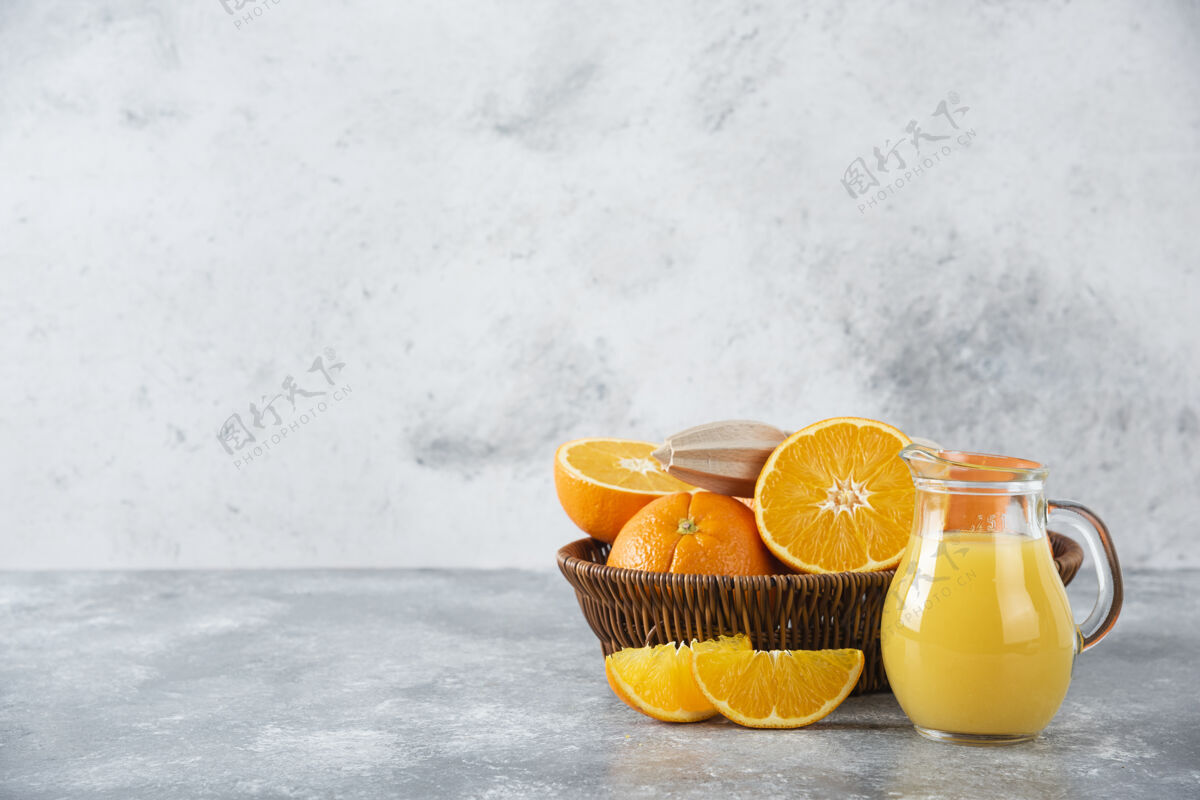 橙子石桌上摆满了柳条盒的多汁橙子甜点橙子异国情调