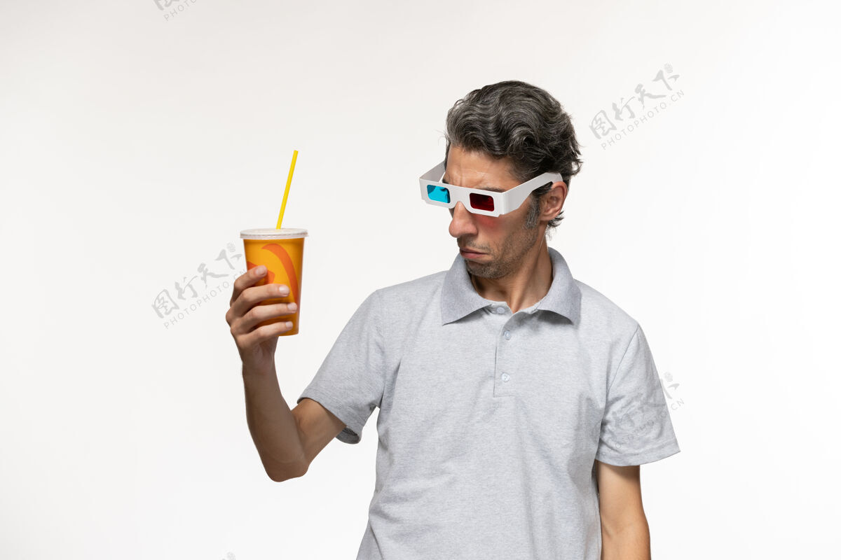 工作正面图：年轻男性手持苏打水 戴着d墨镜 白色表面穿太阳镜苏打水
