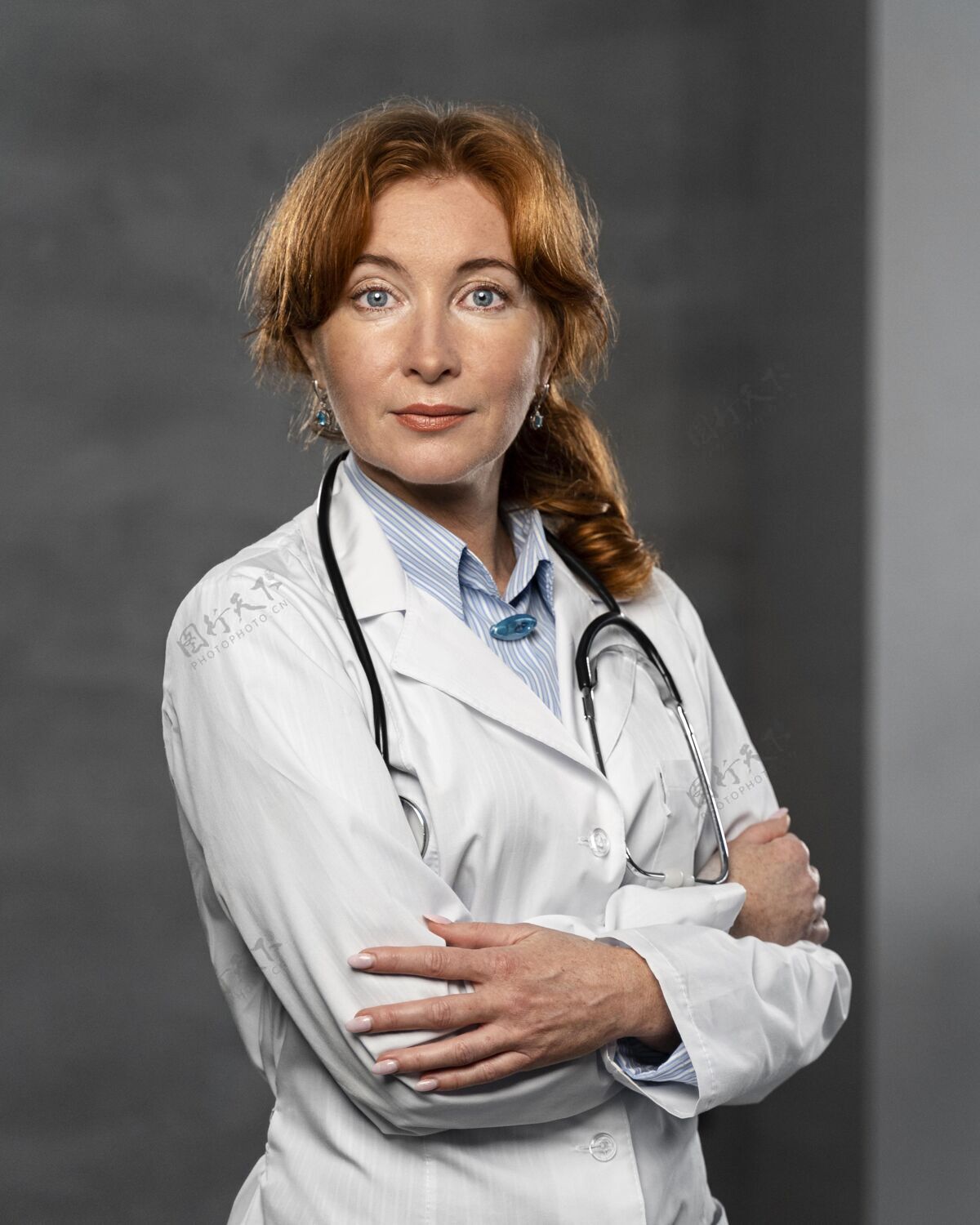 卫生工作者女医生戴听诊器交叉双臂摆姿势的正面图职业临床医生女人