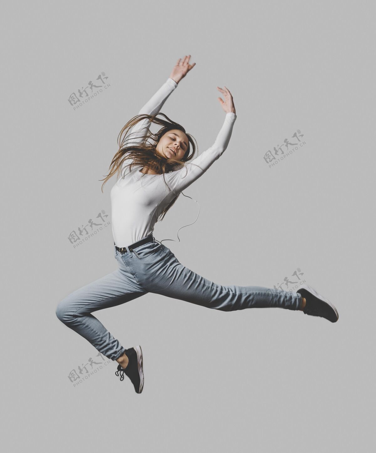 个人戴着耳机在空中跳跃的快乐女人快乐跳跃耳机