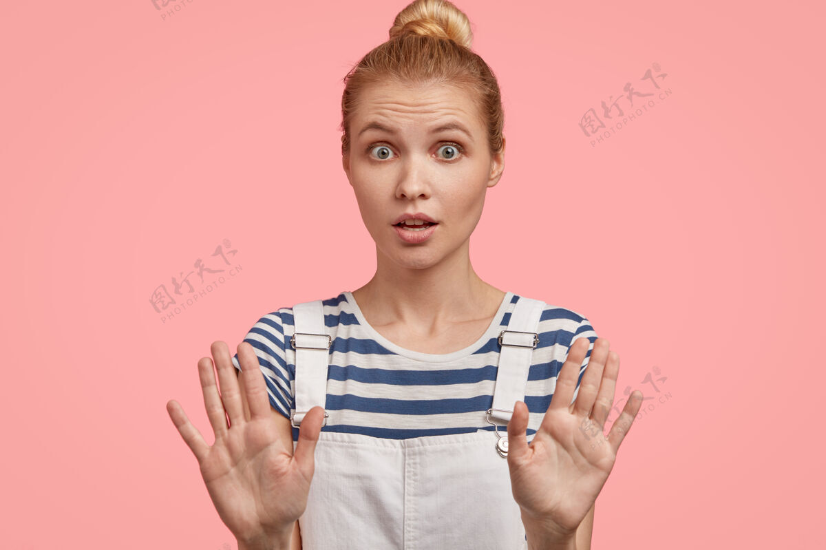 警告欧洲金发女性伸出双手摆姿势 展示停止手势 要求停止 有惊讶害怕的表情 要求不要打扰她 显示禁止 穿着时髦的工作服工作服表情手掌