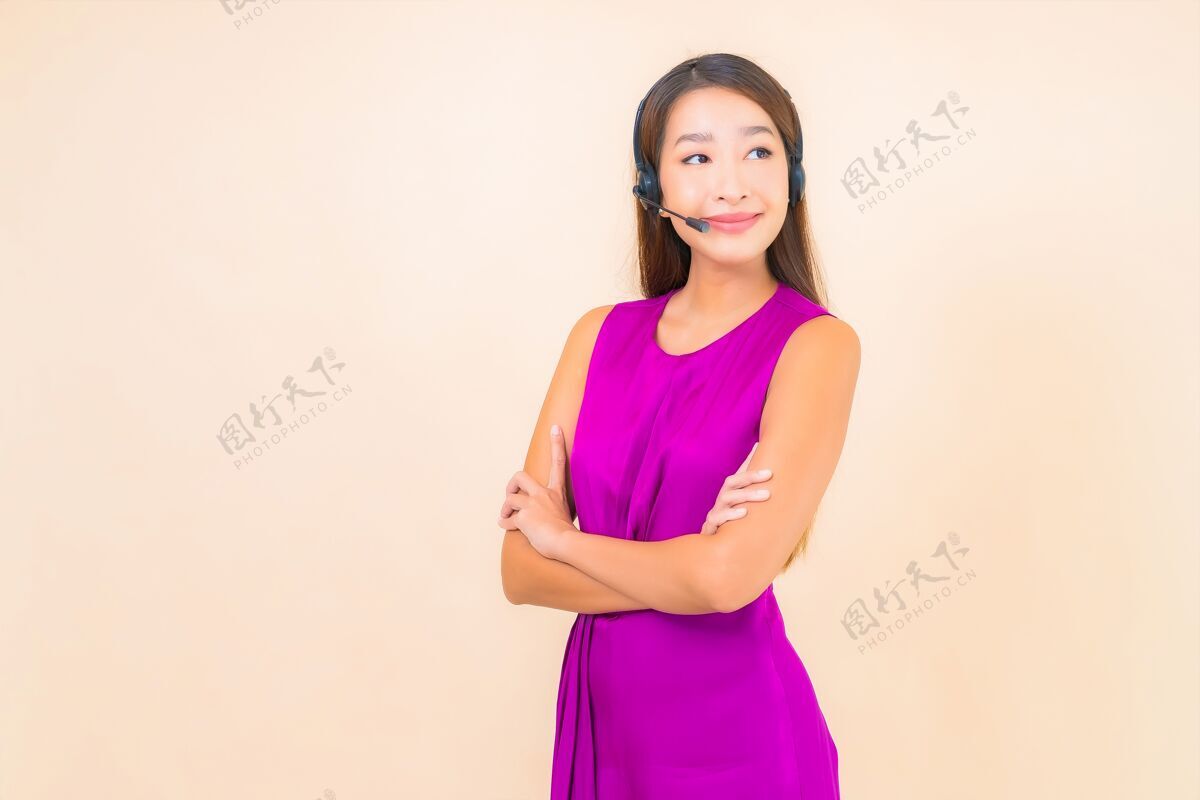 销售在彩色背景上为呼叫中心客户描绘美丽的亚洲年轻女子和耳机耳机服务女商人