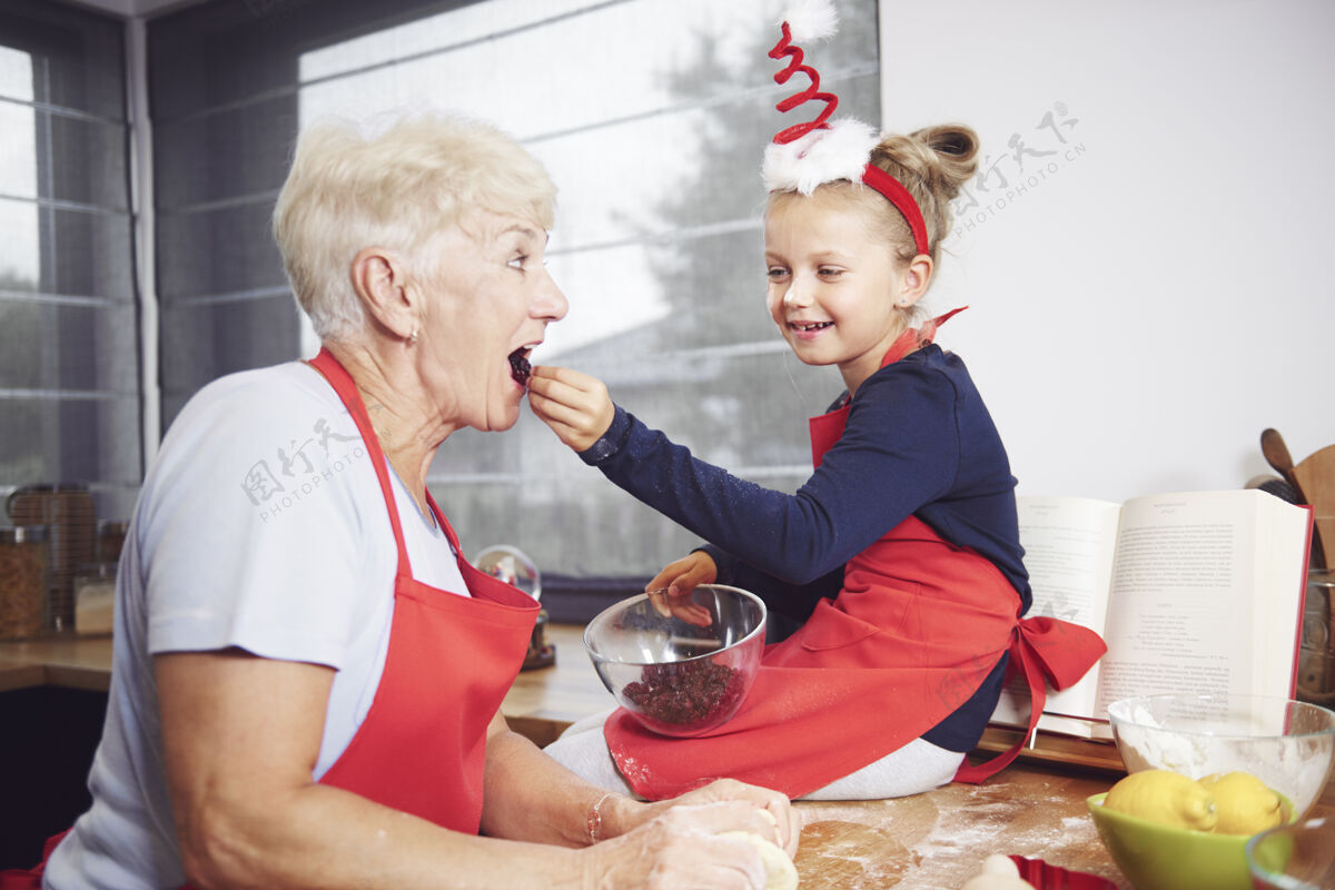 圣诞蛋糕用干果喂奶奶的女孩节日宴会圣诞假期