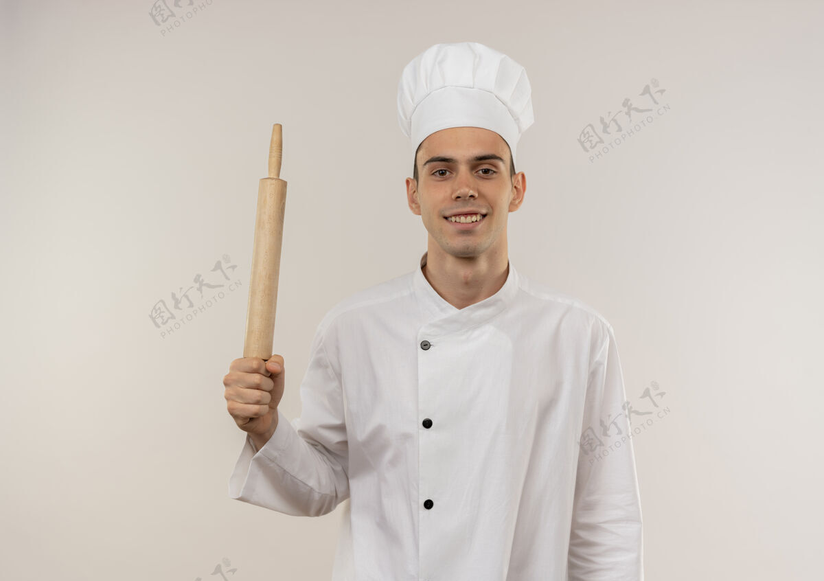 穿着面带微笑的年轻男厨师穿着厨师制服拿着擀面杖与复印空间别针男制服